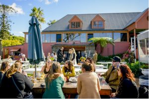 A group relaxing outside at Coolangatta Estate after a wine tasting on a Sydney on tasting tour.