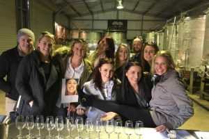 A group having a wine tasting in the wine vat room at Two Figs Winery