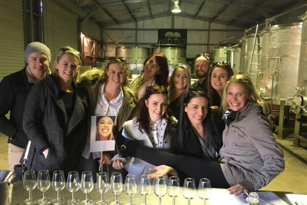 A group having a wine tasting in the wine vat room at Two Figs Winery